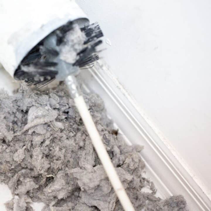 cleaning dryer vent lint buildup to prevent fire hazard