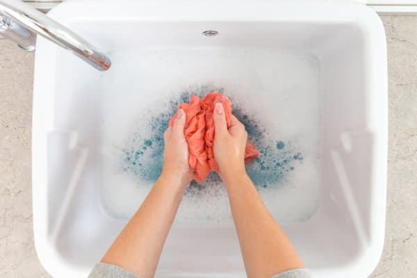 stripping laundry in a tub
