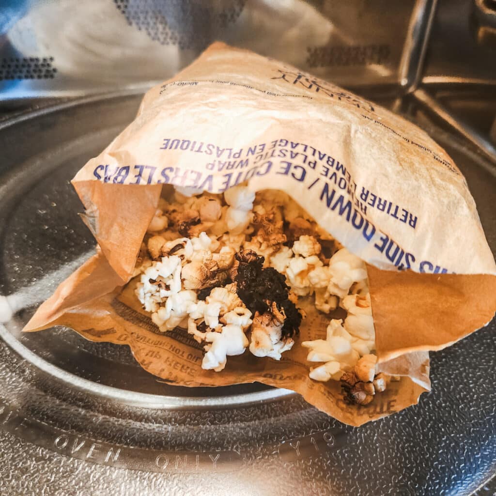 a burnt bag of popcorn in the microwave.