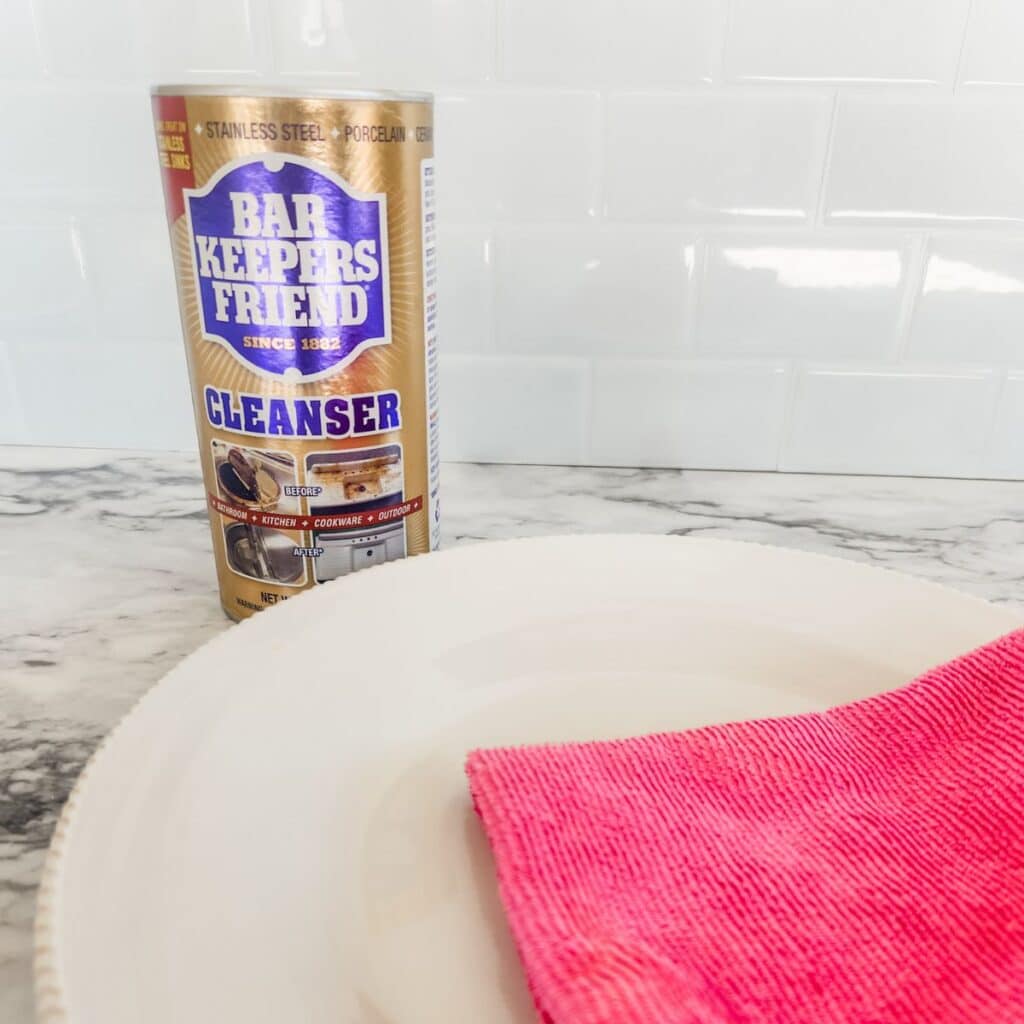 a pink cloth sitting on top of a plate next to bar keepers friend.